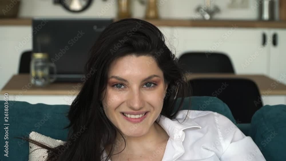 Close up of young attractive caucasian woman with long black hair and blue eyes looking at camera and smiling. Portrait of young brunette girl with beautiful smile and white teeth Close up of young attractive caucasian woman with long black hair and blue eyes looking at camera and smiling. Portrait of young brunette girl with beautiful smile and white teeth