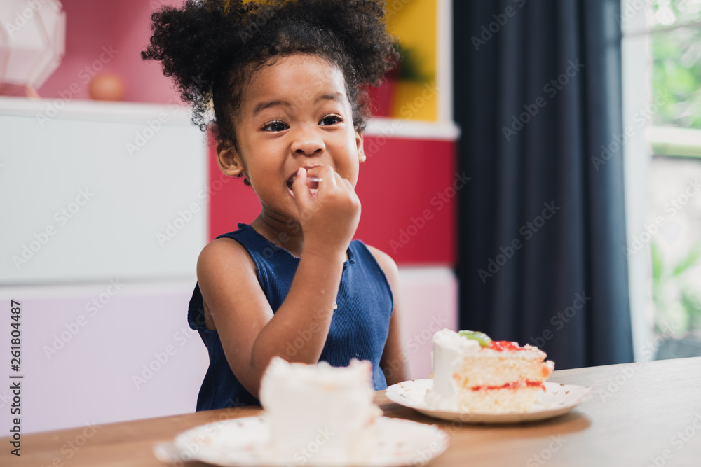 african girl kid eating sweet cake african girl kid eating sweet cake