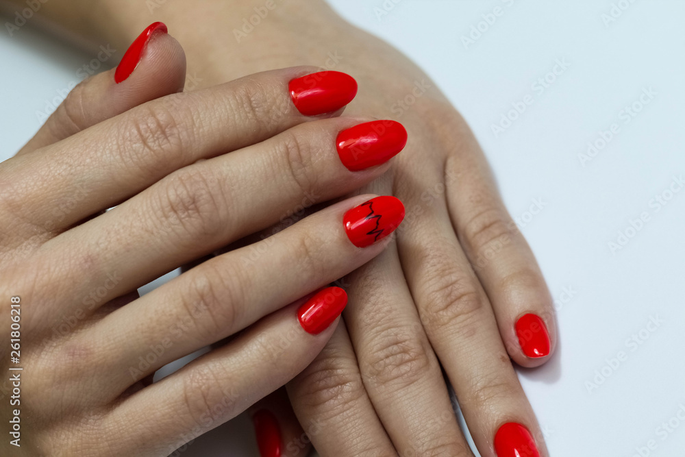 Beautiful nails are covered with red gel lacquer. Woman in a beauty salon. Beautiful nails are covered with red gel lacquer. Woman in a beauty salon.