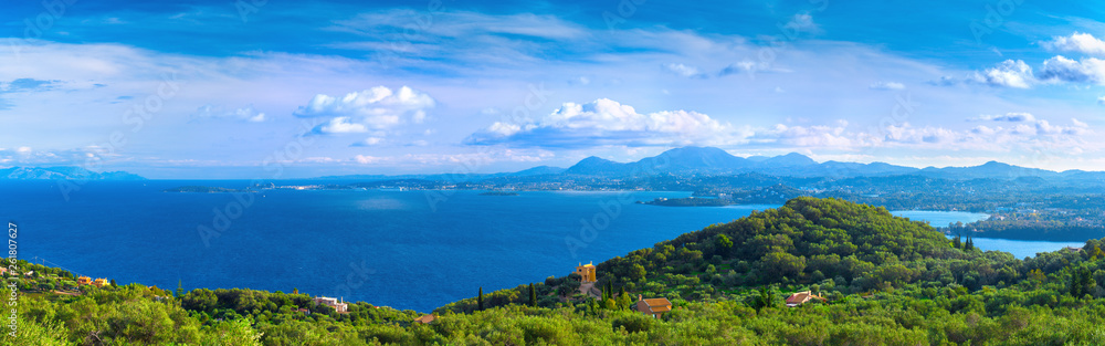 Beautiful summer panoramic seascape. Green slopes in close bays with crystal clear azure water. Coastline of east part Corfu island, Ionian archipelago, Kerkyra, Greece.