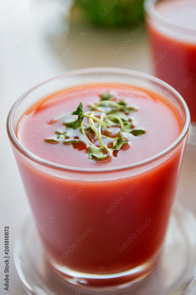 Red tomato juice in a glass, bright morning sun, healthy breakfast Red tomato juice in a glass, bright morning sun, healthy breakfast