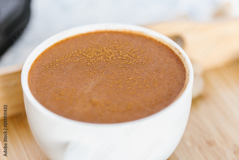 Coffee, sprinkled with cinnamon, soft focus Coffee, sprinkled with cinnamon, soft focus