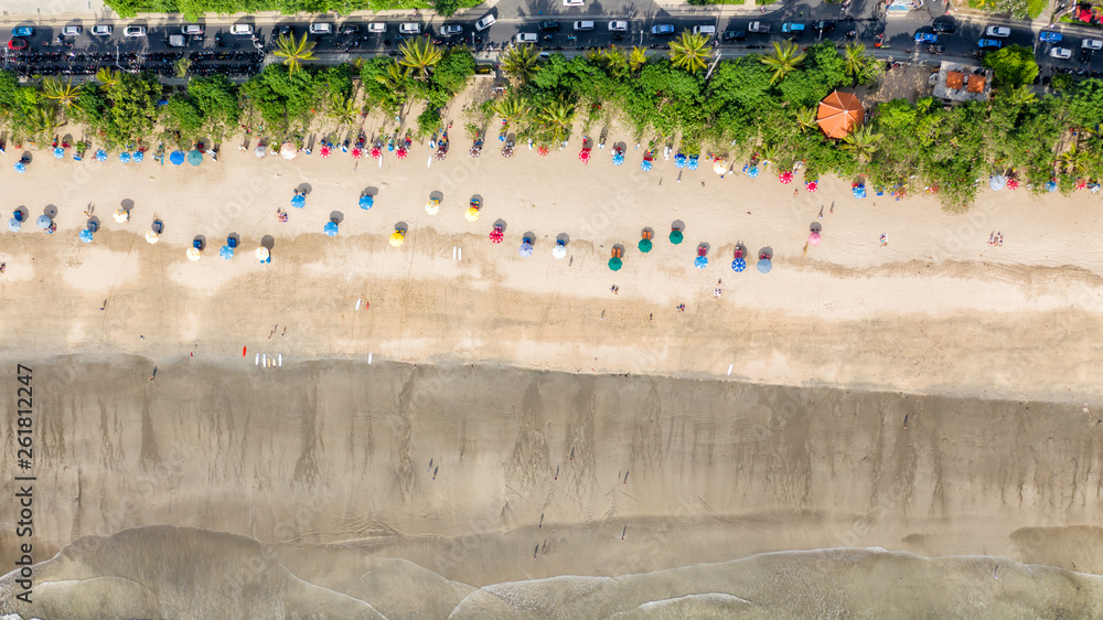 Top aerial view of color umbrellas on the Kuta beach,  Bali
