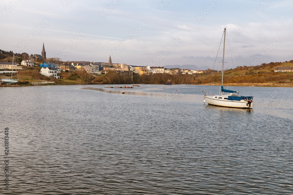 Boat in Clifden bay with village in background