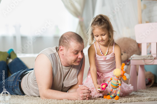 young man playing with his little daughter