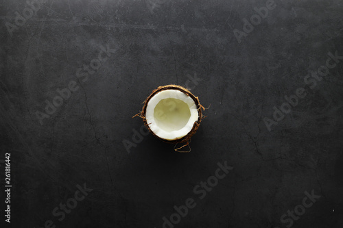 Coconut on a dark stone table. Coconut oil.