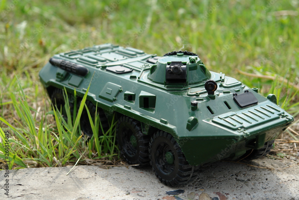 Photo a green toy tank on grass. Theme of meeting, coup or rebellion