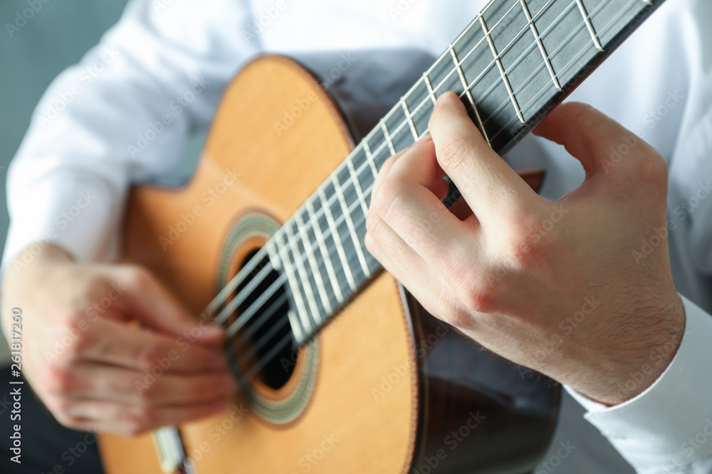 Man playing on classic guitar, space for text Man playing on classic guitar, space for text