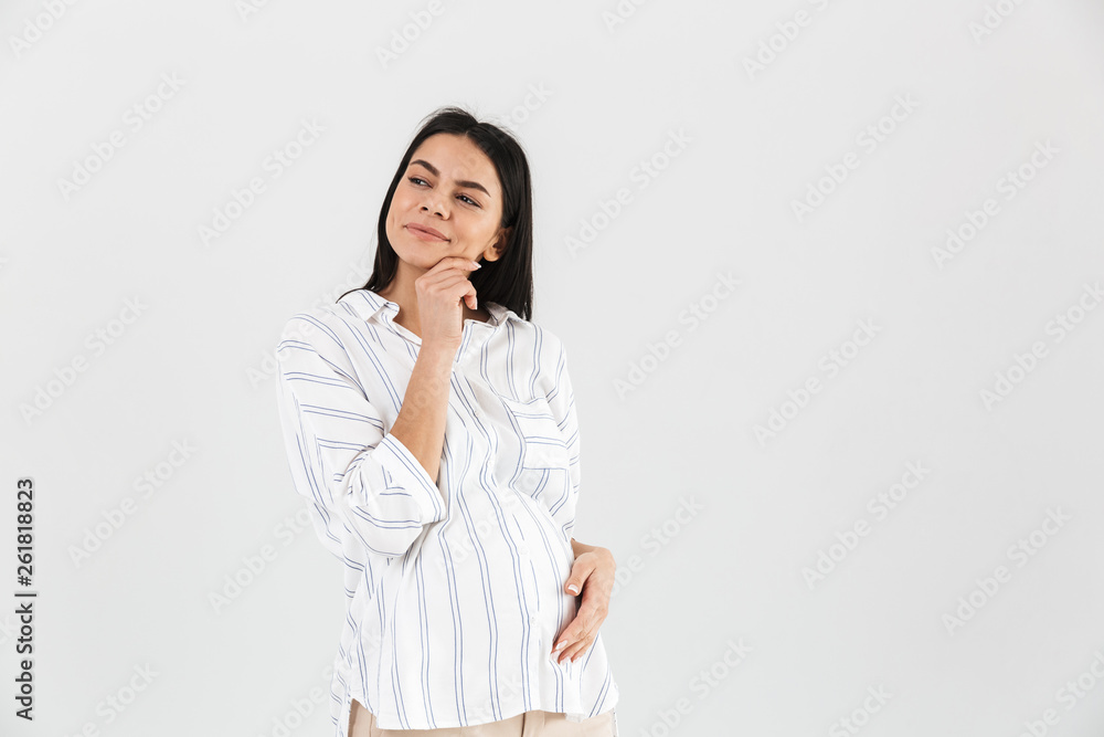 Image of pleased pregnant woman 30s smiling and touching her big tummy Image of pleased pregnant woman 30s smiling and touching her big tummy