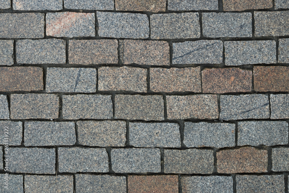 Top view on stone road close up. Pavement of granite. Brown square cobblestone sidewalk. Mock up or vintage grunge texture. Top view on stone road close up. Pavement of granite. Brown square cobblestone sidewalk. Mock up or vintage grunge texture.