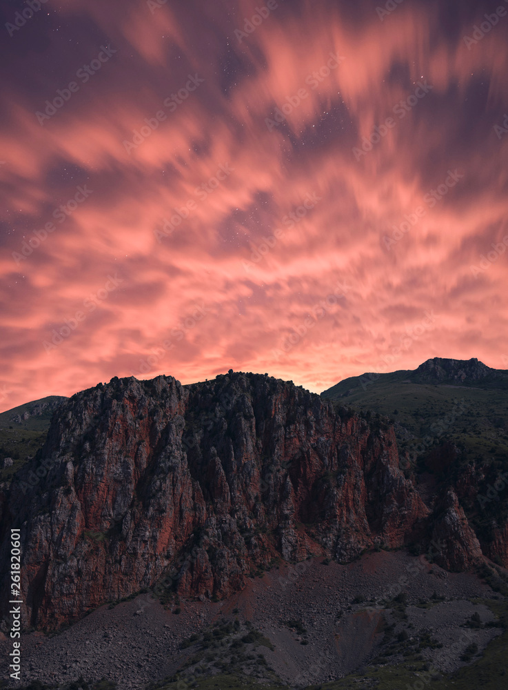 Beautiful red rocks,dramatic clouds at the night . Armenia Noravank.
