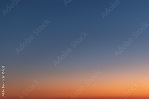 Sky gradient from blue to orange sunset © adekub