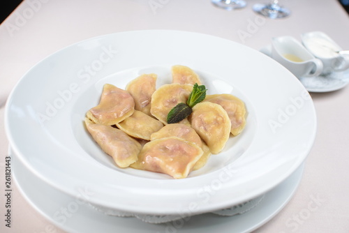 dumplings with strawberries on a white plate