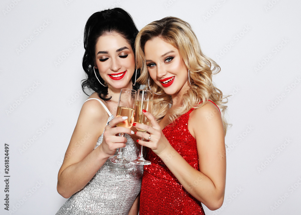 Two in luxury glitter sequins drinking champagne and having fun. Stock-foto | Adobe Stock