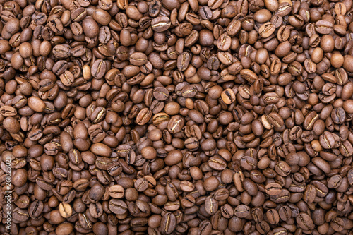 Roasted brown coffee beans pattern. Coffee background. Top view. Flat texture.