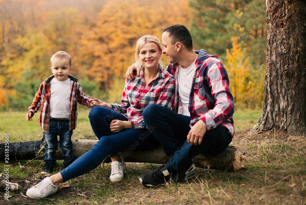 Young family with little son spend time in forest Young family with little son spend time in forest
