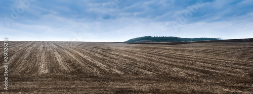 Agriculture landscape with process of planting seeds in the ground as part of the early spring time agricultural activities. photo