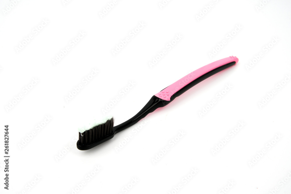 Black and pink toothbrush with toothpaste isolated on white background Black and pink toothbrush with toothpaste isolated on white background