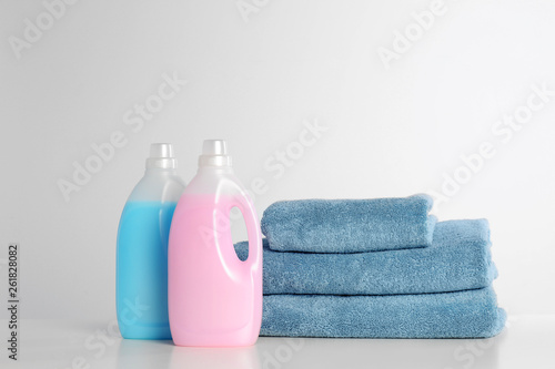 Detergents and clean towels on white background. Laundry day