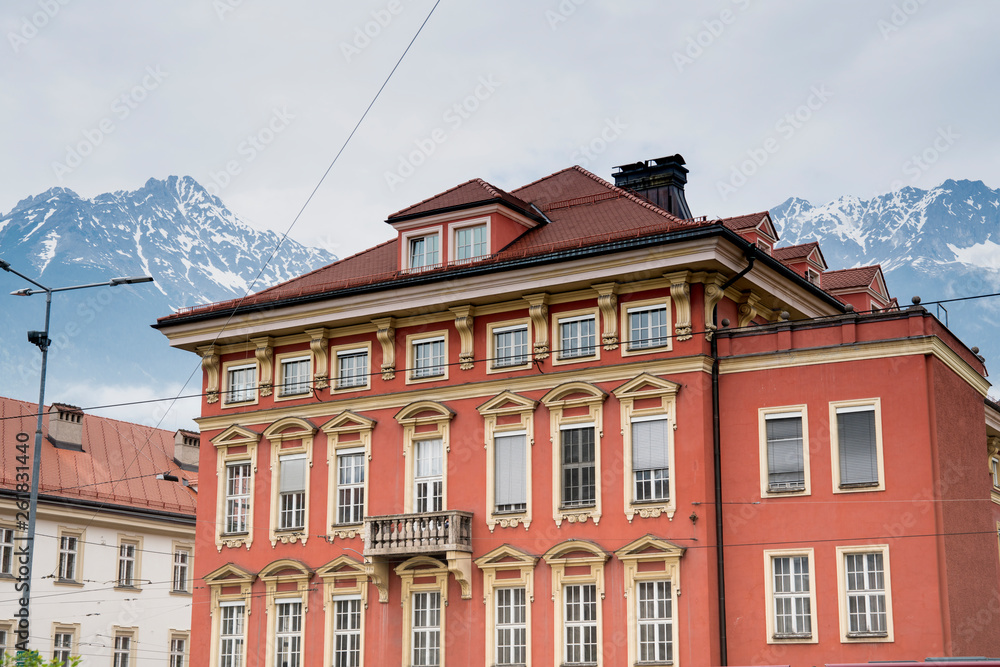 Fototapeta premium orange building in Innsbruck with mountains, Tyrol, Austria