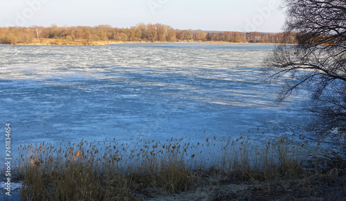 Fototapeta Naklejka Na Ścianę i Meble -  Lake covered with ice in spring on a sunny day