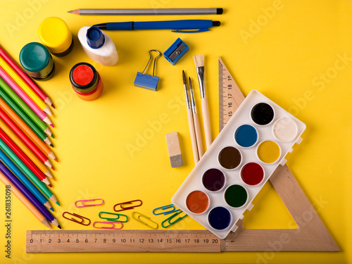 Colorful stationery on yellow background