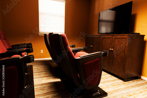 Small Home Theater Room With Cushioned Cinama Chairs photo