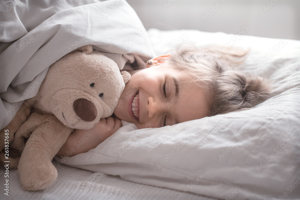 Little cute girl in bed with toy Little cute girl in bed with toy