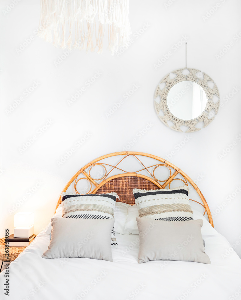 Comfortable hotel bedroom with rattan headboard with natural fabric  cushion, macrame mirror, fiber nightstand and a big window with  view.Holiday destination apartment with boho contemporary style. Photos |  Adobe Stock