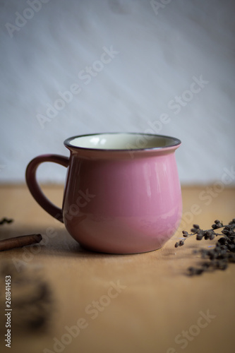 cup of tea with flowers on wooden background