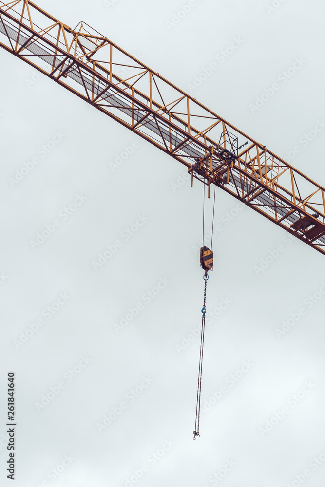 Construction site cranes chains with hooks in the air Construction site cranes chains with hooks in the air