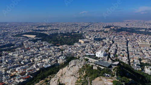 Aerial drone panoramic photo of iconic Saint George Lycabettus chapel as seen from top of hill, all Athens cityscape and Acropolis hill at the background, Athens historic centre, Attica, Greece © aerial-drone