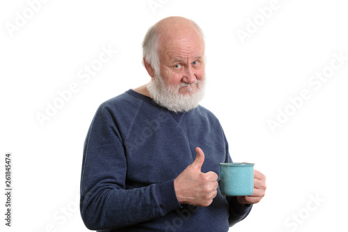 elderly man with cup of bad tea or coffee showing thumb up isolated on white photo