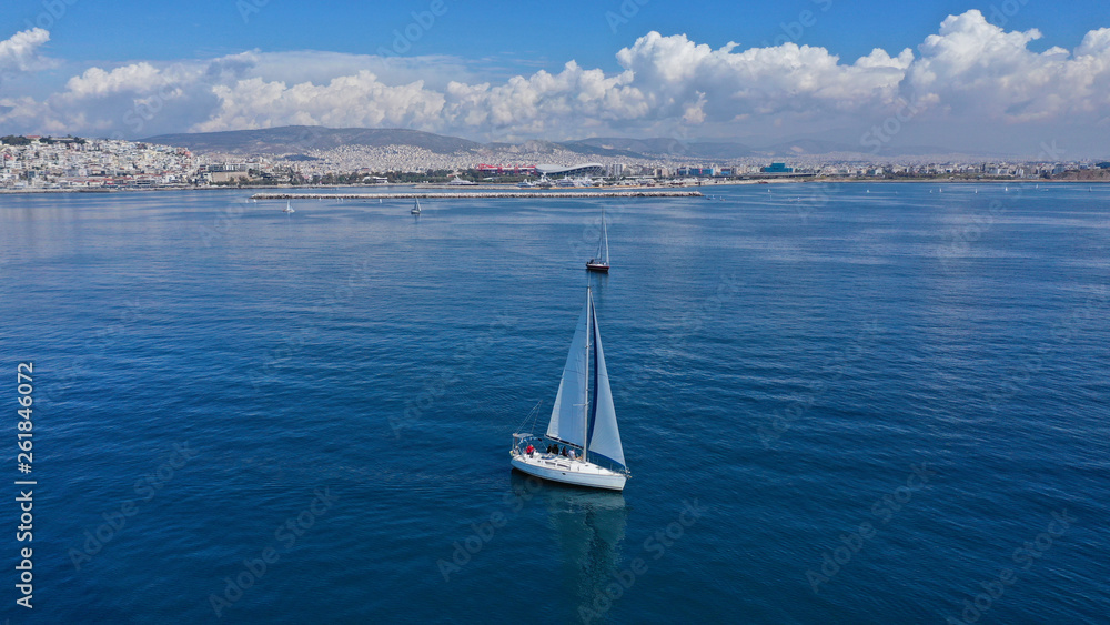 Fototapeta premium Aerial drone birds eye view of sail boat cruising in the deep blue Aegean sea, Greece