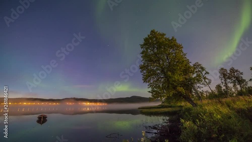 Northern light (aurora borealis) over a lake with fog