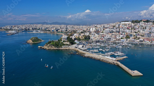 Fototapeta Naklejka Na Ścianę i Meble -  Aerial drone bird's eye view panoramic photo of iconic round shaped picturesque port of Mikrolimano with sail boats and yachts docked and beautiful clouds, Piraeus port, Attica, Greece