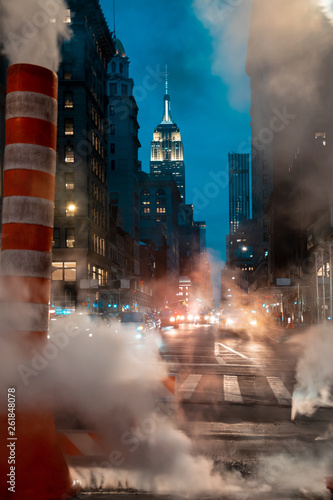 Photography Steam stacks on Midtown Manhattan street with view of the Empire State Building,