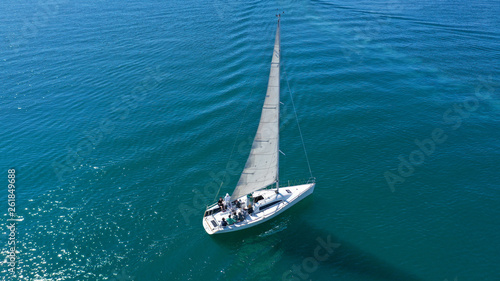 Aerial drone birds eye view of sail boat cruising in the deep blue Aegean sea, Greece