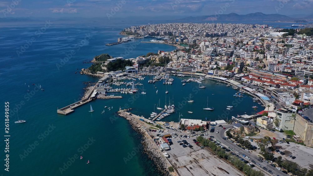 Aerial drone bird's eye view panoramic photo of iconic round shaped picturesque port of Mikrolimano with sail boats and yachts docked and beautiful clouds, Piraeus port, Attica, Greece