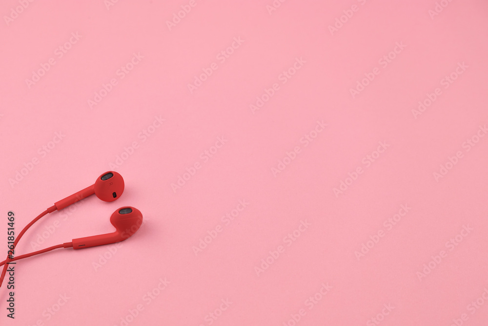 Red earphones on background Red earphones on background