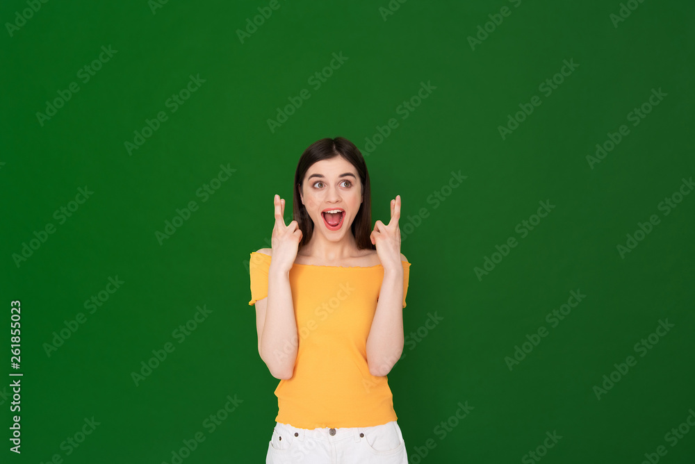 Excited pretty young girl wishing to reach a goal Excited pretty young girl wishing to reach a goal