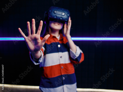 The girl is amazed at the game in virtual reality.