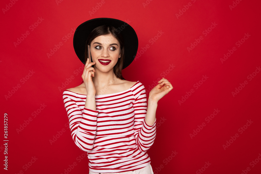 Coquettish young girl talking by mobile phone Coquettish young girl talking by mobile phone