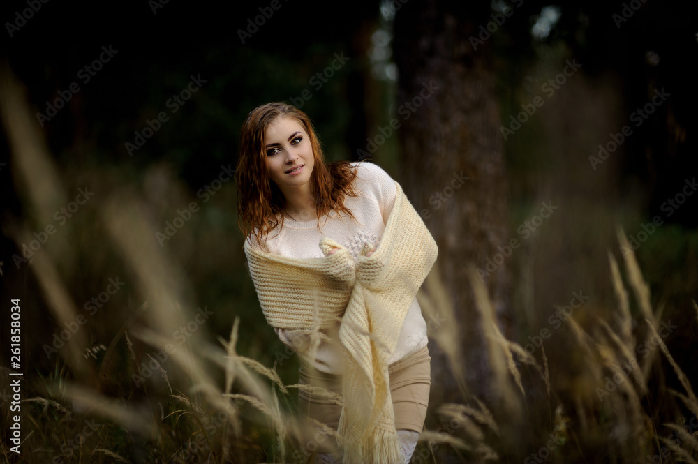 red-haired girl in bright clothes on a background of autumn forest and yellow ears on a sunny day red-haired girl in bright clothes on a background of autumn forest and yellow ears on a sunny day