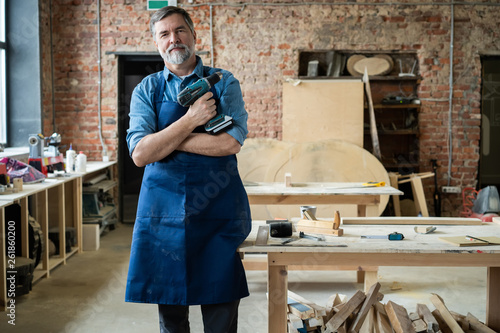 Photography Mature handsome joiner work in carpentry