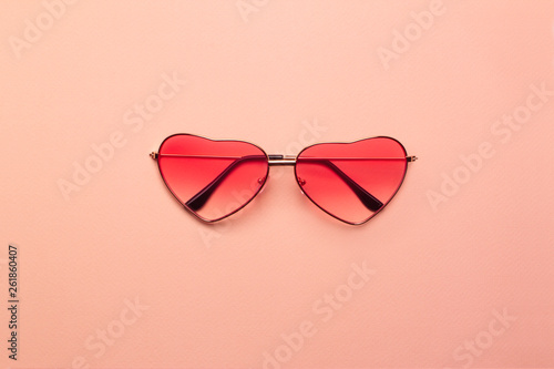 Bright coral heart-shaped glasses on a orange paper background. © Soleness Moon