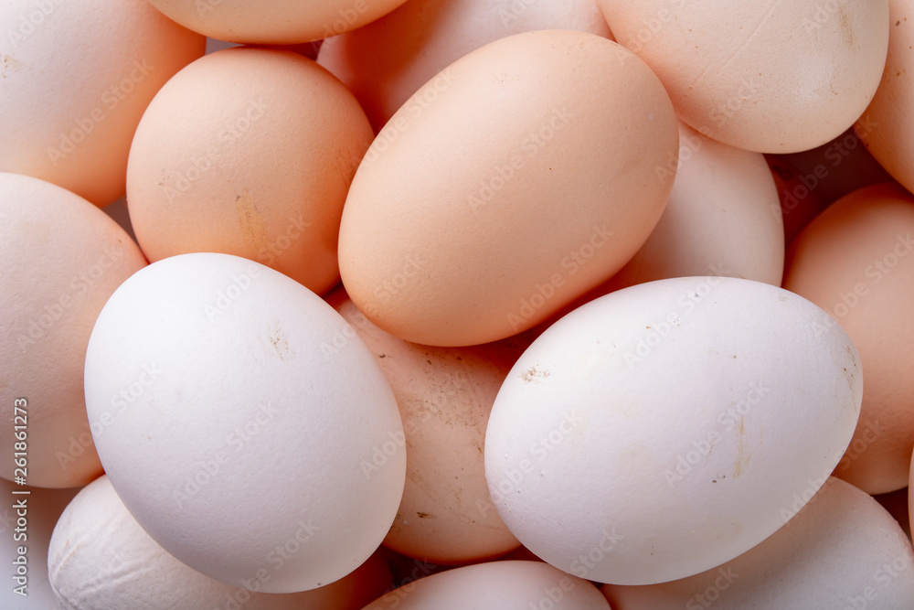 Fresh chicken eggs stacked on top of each other. A pile of eggs on the kitchen table. Fresh chicken eggs stacked on top of each other. A pile of eggs on the kitchen table.