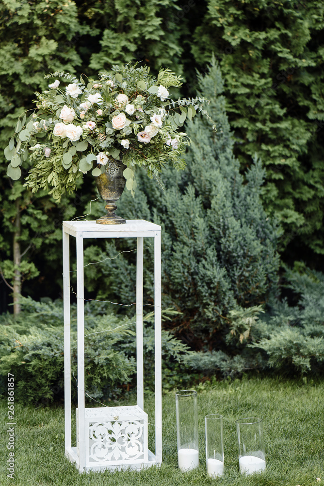 Beautiful festive bouquet of flowers from a variety of greenery and white roses. Outdoors. Beautiful festive bouquet of flowers from a variety of greenery and white roses. Outdoors.