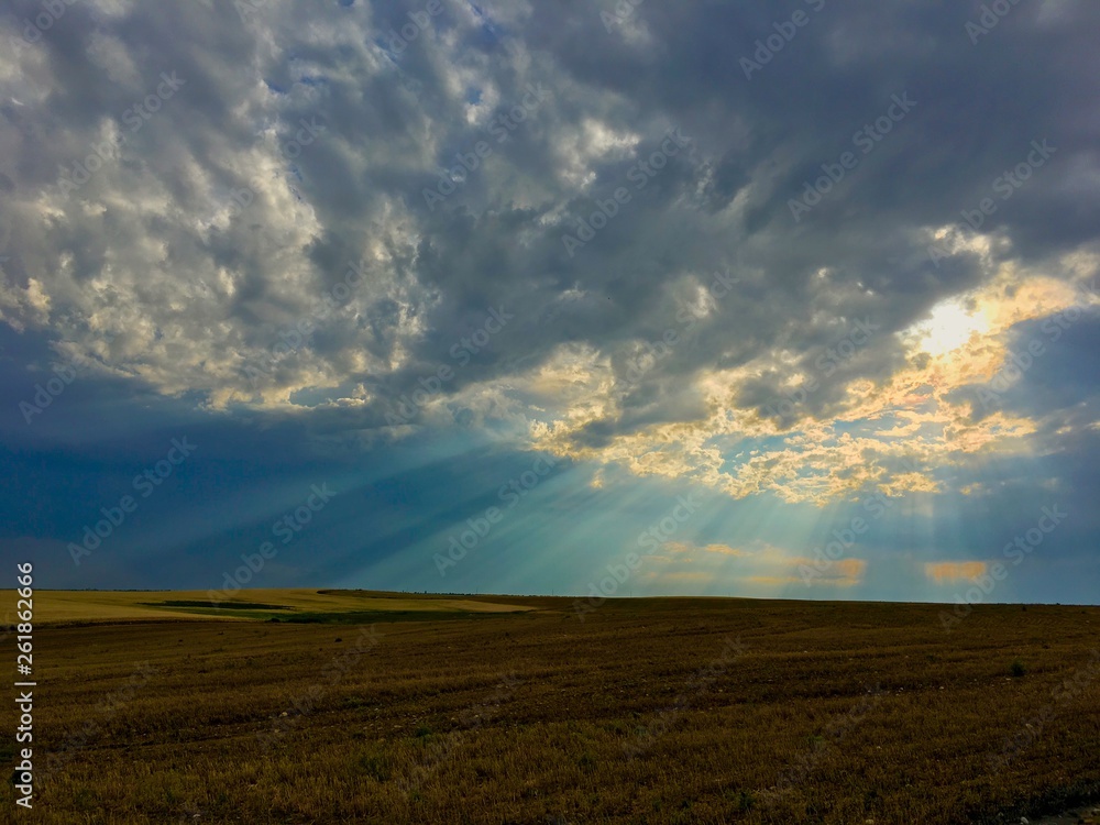 The sun rays sneaking through the sunset rain. The sun rays sneaking through the sunset rain.