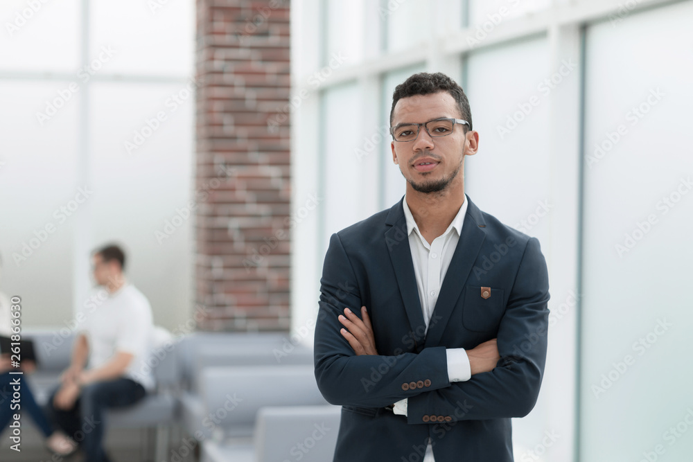 young businessman on the background of a modern office young businessman on the background of a modern office
